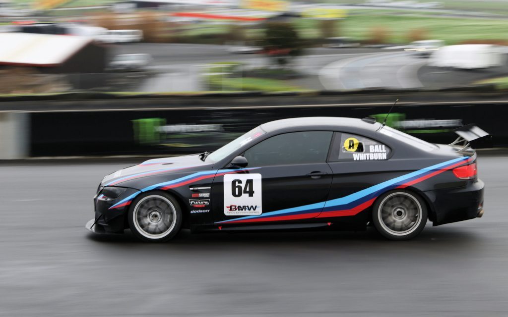 BMW M3 E92 racing at Hampton Downs in wet conditions