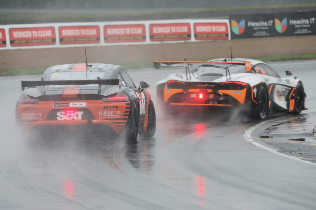 Porsche 918 GT4 car racing McLaren 720S GT3 at Hampton Downs in wet conditions