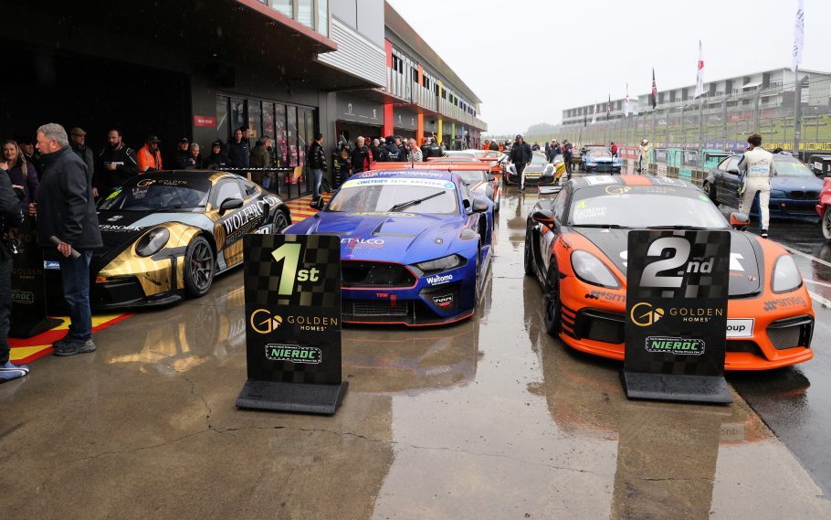 Marc Gen 2 Mustang, Porsche GT4, and Porsche 992 on podium