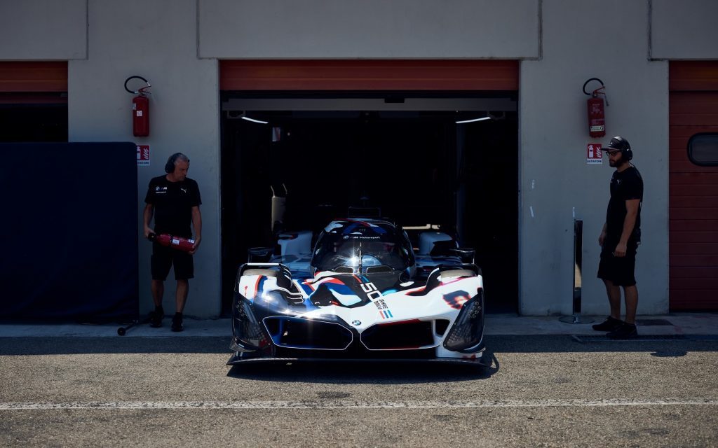 BMW M Hybrid V8 LMDh exiting pit garage at Dallara test track front