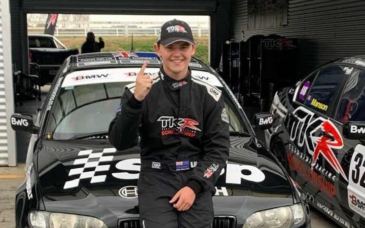 Harry McDonald TKR scholarship racing driver standing in front of BMW E46