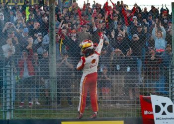 Scott McLaughlin on fence in front of fans after Supercars race win at Pukekohe Park Raceway