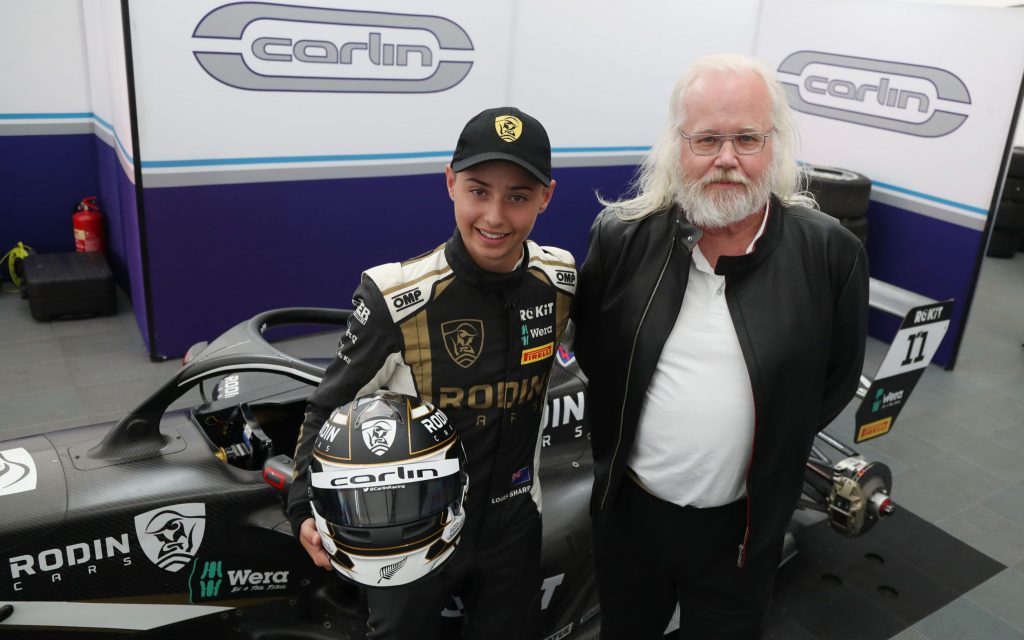 Louis Sharp and David Dicker standing in front of Carlin Formula 4 car