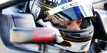 Louis Sharp sitting in Formula 4 car with helmet on