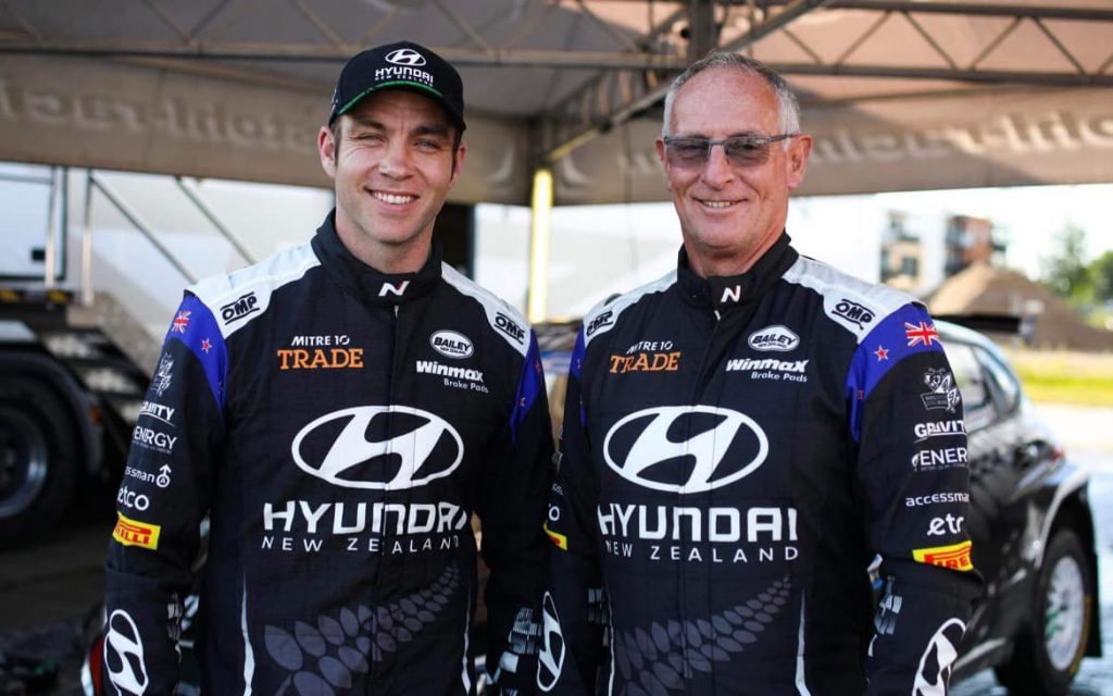 Hayden Paddon and John Kennard standing in Hyundai service tent