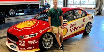 Scott McLaughling standing next to championship winning Ford Falcon FG X Supercar