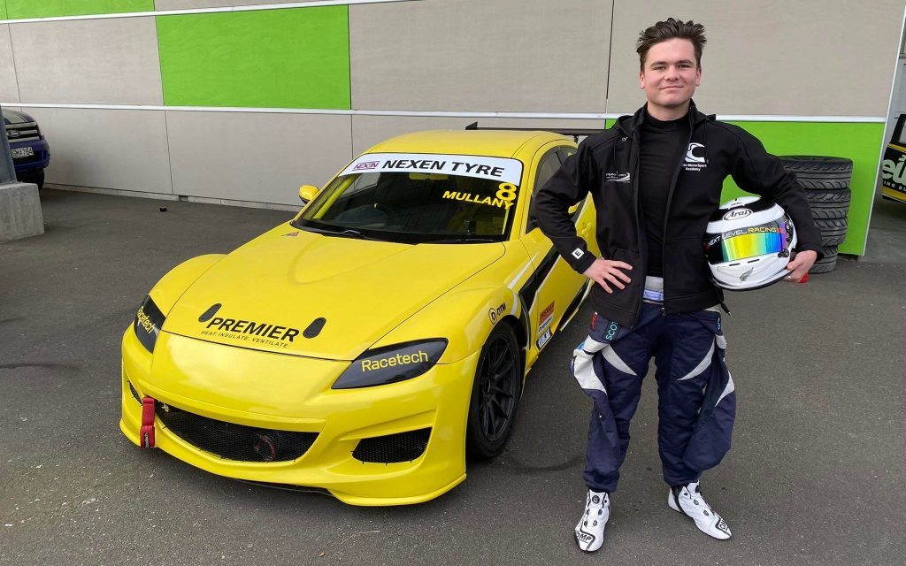 Flynn Mullany standing next to Mazda RX8 front three quarter view