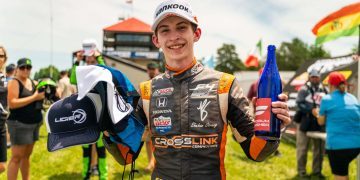 Ryan Shehan holding podium bottle