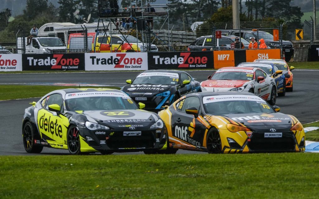 Two Toyota TR86 race cars battling on track