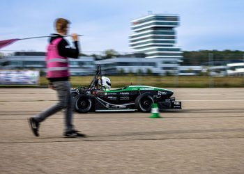 EV accelerating past man on road