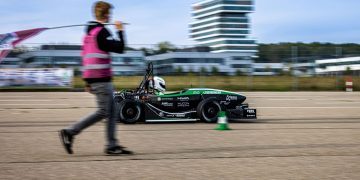 EV accelerating past man on road