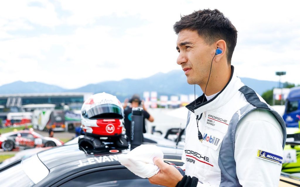 Jaxon Evans standing next to race car