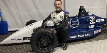 James Penrose sitting with Formula Ford car