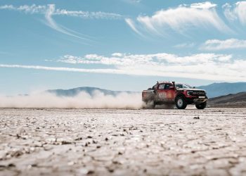 Ford Ranger Raptor Baja race truck driving at speed front three quarter view