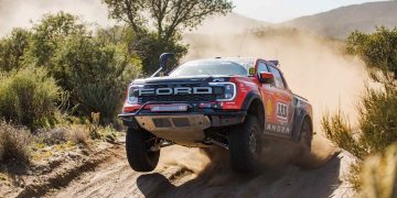 Ford Ranger Raptor Baja race truck jumping on sand dune
