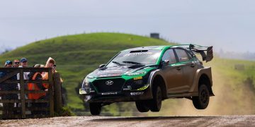 Hayden Paddon jumping Hyundai Kona EV rally car