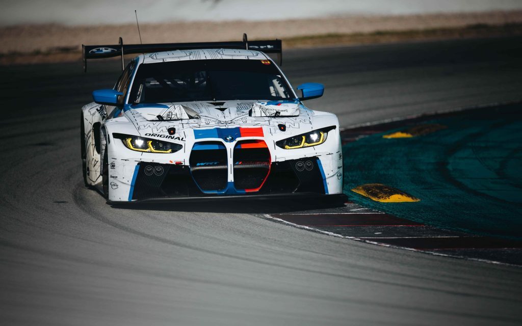 BMW M4 GT3 car racing on track front view