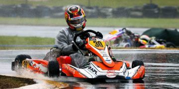 Liam Lawson racing go kart in wet conditions