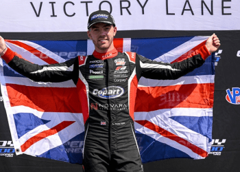 Louis Foster holding up United Kingdom flag celebrating win