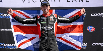 Louis Foster holding up United Kingdom flag celebrating win