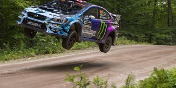 Ken Block jumping Subaru Impreza WRX rally car