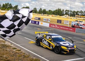 Simon Baker crossing finish line in Mazda RX8 at Ruapuna