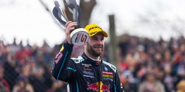 Shane van Gisbergen holding trophy at Supercars Pukekohe