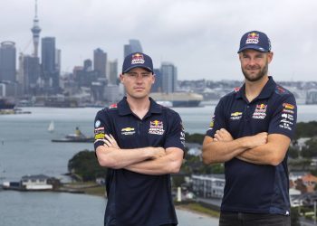 Richie Stanaway and Shane van Gisbergen standing in front of Auckland city