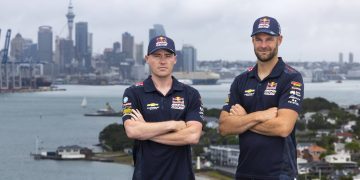 Richie Stanaway and Shane van Gisbergen standing in front of Auckland city