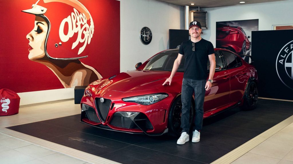 Alfa Romeo F1 Team driver standing next to his new Giulia GTAm