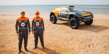 Tanner Foust and Emma Gilmour standing next to NEOM McLaren Extreme E car