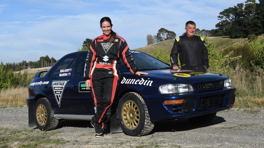 Olympic BMX gold medalist Sarah Walker standing next to Subaru Impreza rally car