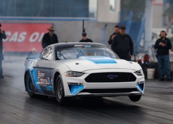 Electric Ford Mustang Super Cobra Jet doing wheelie on drag strip