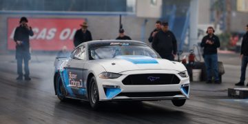 Electric Ford Mustang Super Cobra Jet doing wheelie on drag strip