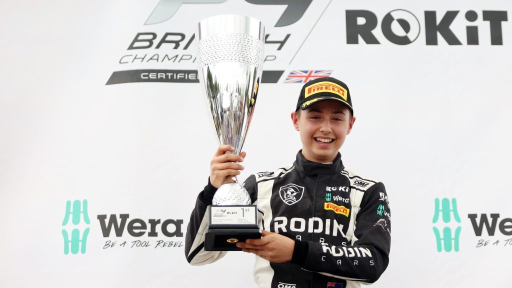 Louis Sharp holding first place trophy in Formula 4