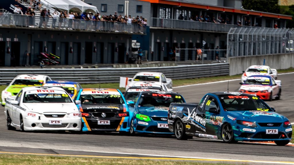 V8 Utes racing into turn one at Taupo Motorsport Park