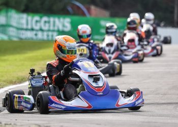 Karters racing down track in line