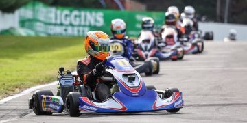 Karters racing down track in line