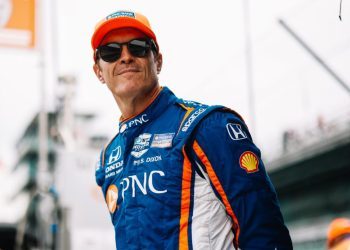 Scott Dixon standing with hands behind back