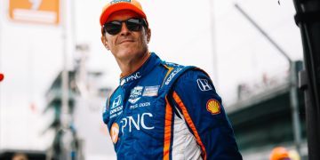 Scott Dixon standing with hands behind back