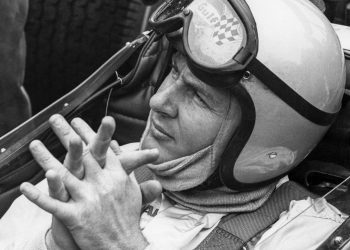 Bruce McLaren sitting in F1 car