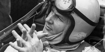 Bruce McLaren sitting in F1 car