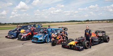 Liam Lawson standing with F1 car next to MotoGP bike, WRC rally car, Rallycross car and Ford E-Transit Supervan