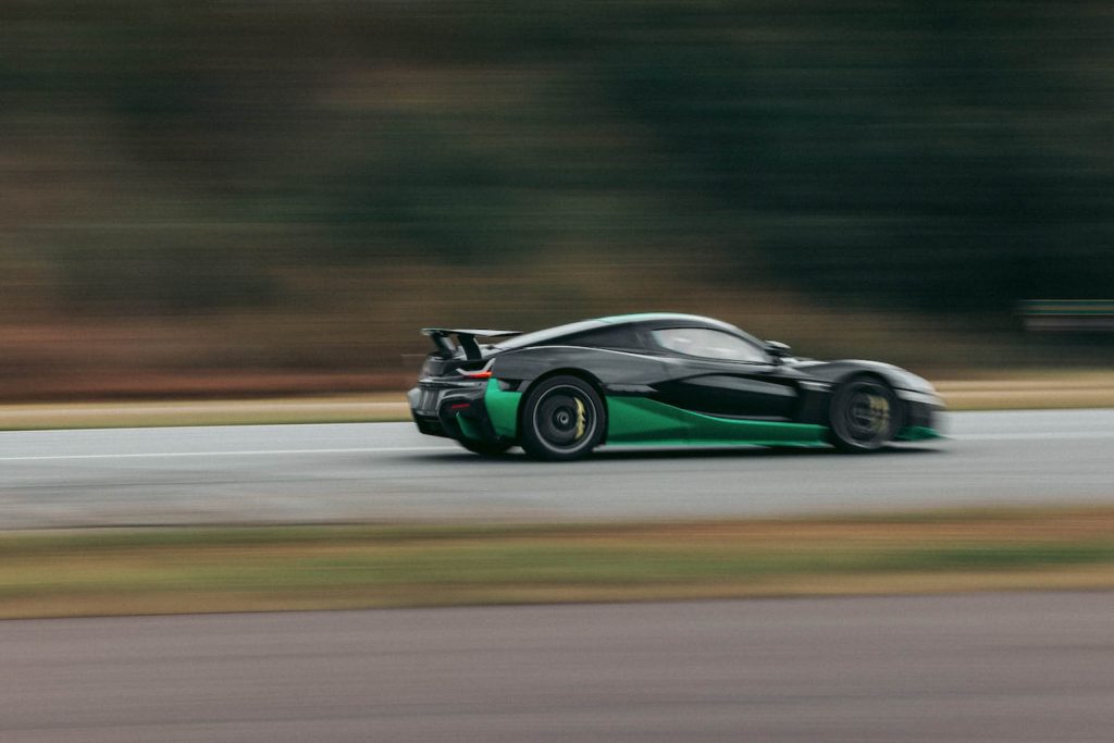 Rimac Nevera reversing at speed past trees