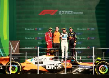 MEXICO CITY, MEXICO - OCTOBER 26: Race winner Lando Norris of Great Britain and McLaren Second placed Charles Leclerc of Monaco and Scuderia Ferrari Third placed Max Verstappen of the Netherlands and Oracle Red Bull Racing and Andrew Jarvis, Performance Engineer at McLaren on the podium during the F1 Grand Prix of Mexico at Autodromo Hermanos Rodriguez on October 26, 2025 in Mexico City, Mexico. (Photo by Hector Vivas/Getty Images) // Getty Images / Red Bull Content Pool // SI202510260891 // Usage for editorial use only //