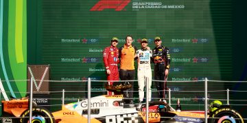 MEXICO CITY, MEXICO - OCTOBER 26: Race winner Lando Norris of Great Britain and McLaren Second placed Charles Leclerc of Monaco and Scuderia Ferrari Third placed Max Verstappen of the Netherlands and Oracle Red Bull Racing and Andrew Jarvis, Performance Engineer at McLaren on the podium during the F1 Grand Prix of Mexico at Autodromo Hermanos Rodriguez on October 26, 2025 in Mexico City, Mexico. (Photo by Hector Vivas/Getty Images) // Getty Images / Red Bull Content Pool // SI202510260891 // Usage for editorial use only //